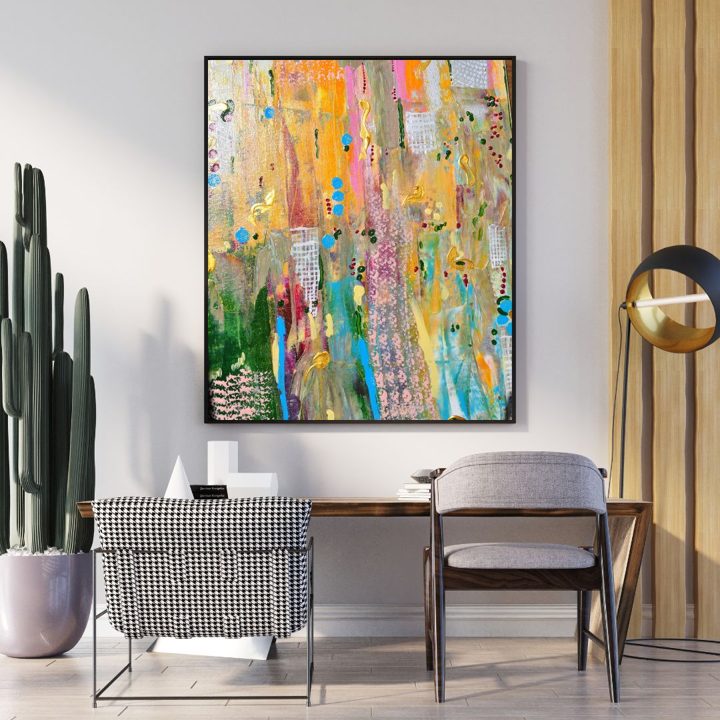 City Lights, a colourful abstract painting with gold, pink and turquoise, hanging above a desk